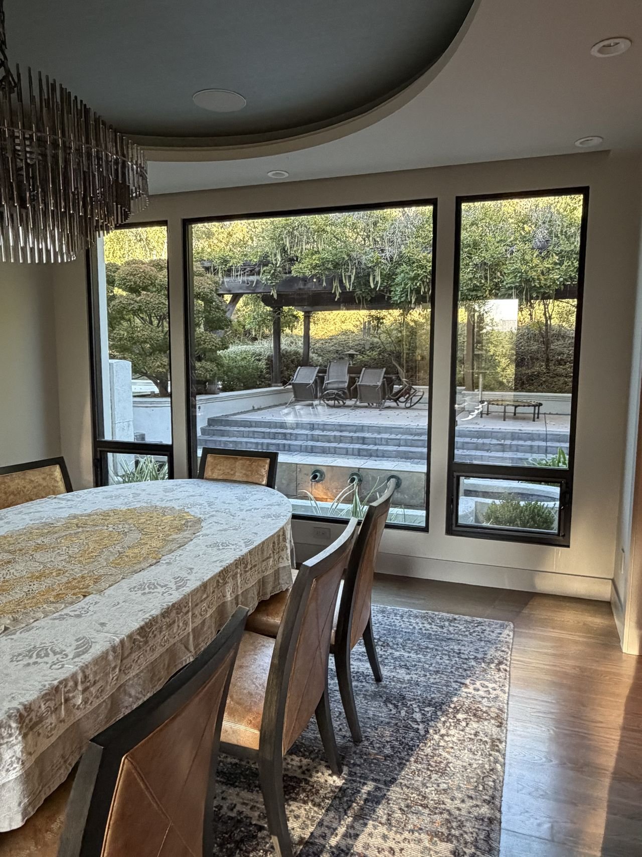 A dining room with freshly cleaned windows looking out on a garden patio